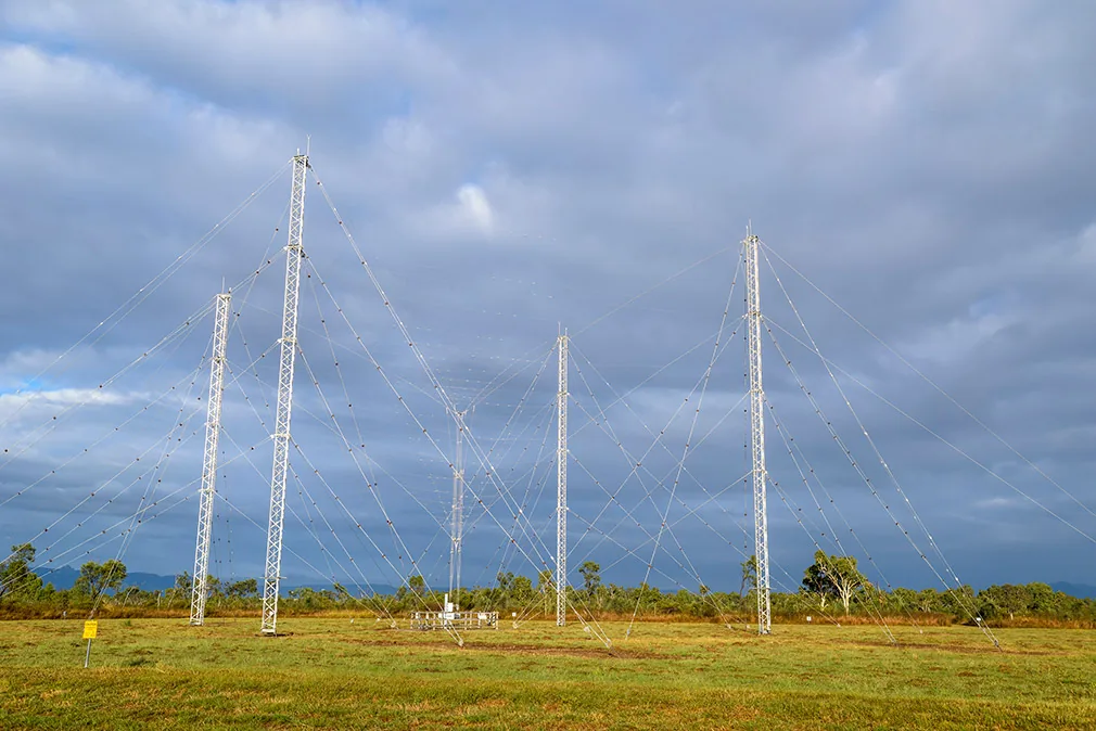 Ground-station antenna masts against the sky