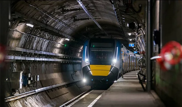 Train running through a rail tunnel.